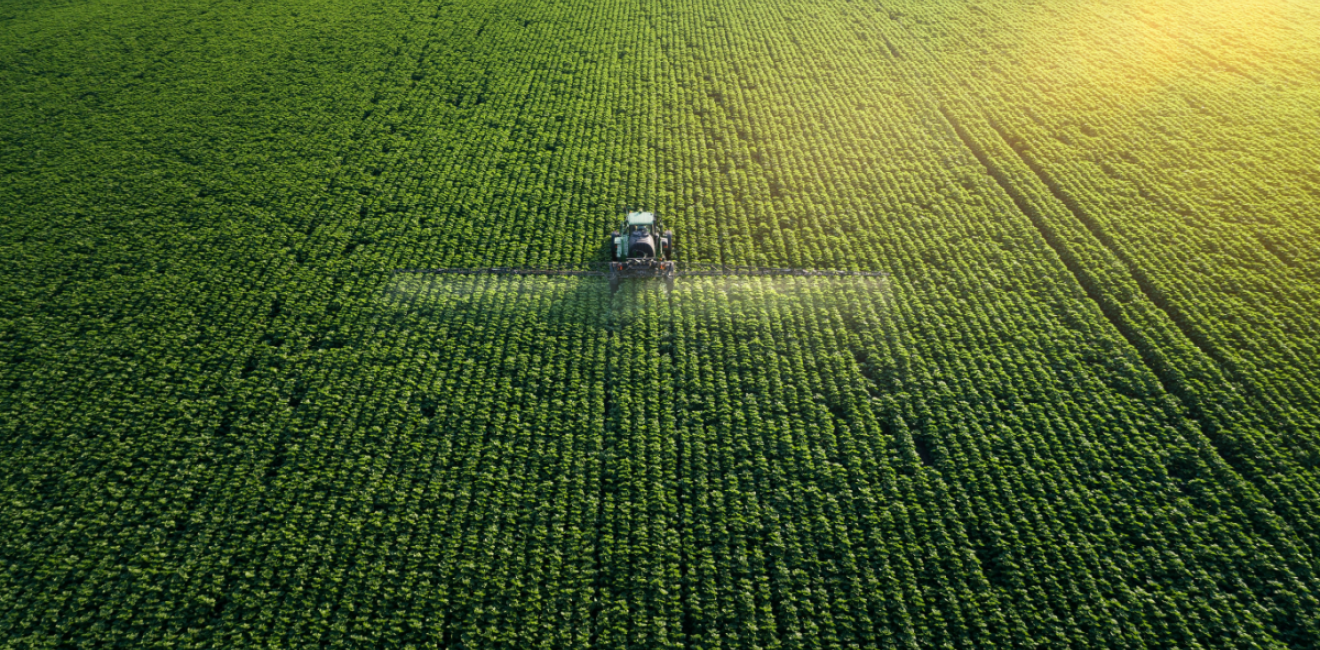 Aerial view of a tractor fertilizing a field