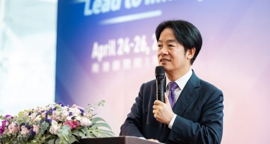 Vice President Lai Ching-te speaking at a podium at an event.