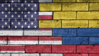 US and Colombian flags painted on a brick wall