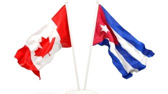 Two waving flags of Canada and cuba isolated on white