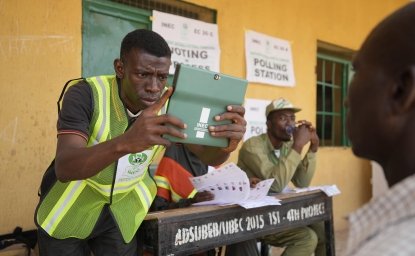 A man has his photo taken by an electoral worker before voting during the presidential elections in Yola, Nigeria, Saturday, February 25, 2023.