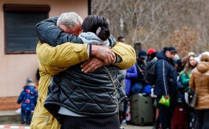 Ukrainian refugees embrace