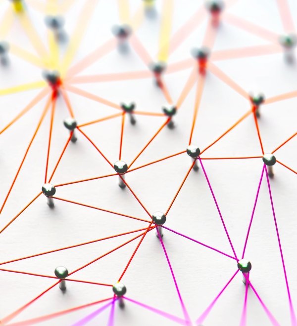Linking entities. Networking, social media, SNS, internet communication abstract. Small network connected to a larger network. Web of red, orange and yellow wires on white background.
