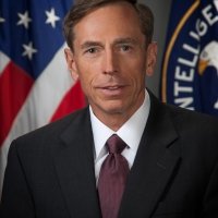 A portrait of Petraeus standing in front of an American flag and the seal of the CIA.