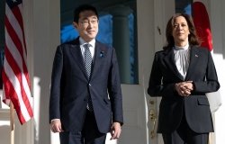 Japanese Prime Minister Fumio Kishida and U.S. Vice President Kamala Harris stand in front of a building.