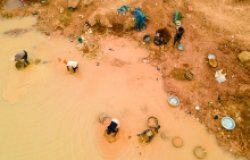 Kunsu, Ghana, March 20, 2023: Rural Women in Small Scale Mining (Galamsey) in Ghana, Africa. The quest for the daily meal of these women relies on them finding gold in an already mined land.