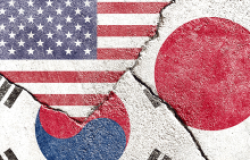 US, South Korea, and Japan Flags on concrete