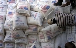 In this June 4, 2008 file photo, Palestinians unload bags of flour donated by the United States Agency for International Development, USAID, at a depot in the West Bank village of Anin near Jenin. AP Photo/Mohammed Ballas.