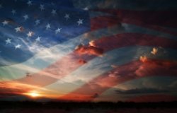 American flag against clouds